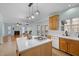Kitchen island with gas range and sink with a view of the living room at 5401 Green Feather Ln, Raleigh, NC 27604