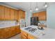 Bright kitchen featuring honey oak cabinets, stainless steel appliances, and a center island with a gas stovetop at 5401 Green Feather Ln, Raleigh, NC 27604