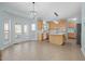 Bright kitchen with an island, modern lighting, and access to the outdoor patio at 5401 Green Feather Ln, Raleigh, NC 27604