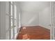 Bright, sunlit living room with pristine white walls and rich hardwood flooring at 5401 Green Feather Ln, Raleigh, NC 27604