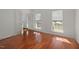 Bright living room featuring hardwood floors, windows, and an open entryway at 5401 Green Feather Ln, Raleigh, NC 27604