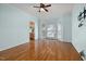 Living room showcasing hardwood floors, light blue walls, bay windows, and view to the kitchen at 5401 Green Feather Ln, Raleigh, NC 27604