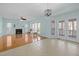 Open-concept living room with fireplace, chandelier, and access to the outdoor patio at 5401 Green Feather Ln, Raleigh, NC 27604