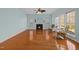 Spacious living room features a fireplace, hardwood floors and large windows at 5401 Green Feather Ln, Raleigh, NC 27604