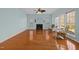 Spacious living room features a fireplace, hardwood floors and large windows at 5401 Green Feather Ln, Raleigh, NC 27604