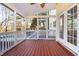 Covered porch offering a view of the swimming pool from the stained wood floor at 5401 Green Feather Ln, Raleigh, NC 27604