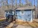 Charming single-story home with blue siding, surrounded by a beautiful wooded area and inviting front entrance at 5500 Bobbitt Rd, Apex, NC 27539