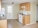 Functional kitchen featuring wood cabinets, updated appliances, and access to the backyard through the back door at 5500 Bobbitt Rd, Apex, NC 27539