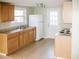 Functional kitchen featuring wood cabinets, updated appliances, and natural light streaming in from the large window at 5500 Bobbitt Rd, Apex, NC 27539
