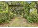 Backyard features a covered arbor with lush greenery at 613 S Fuquay Ave, Fuquay Varina, NC 27526