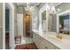 Bathroom with walk-in shower, vanity with lots of counter space and a large window at 613 S Fuquay Ave, Fuquay Varina, NC 27526