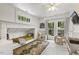 Bedroom featuring built-in bed, adjacent playroom, and multiple windows for ample light at 613 S Fuquay Ave, Fuquay Varina, NC 27526