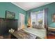 The bedroom features a black fireplace, a comfortable bed, and a sunlit window at 613 S Fuquay Ave, Fuquay Varina, NC 27526