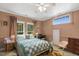 Bedroom featuring neutral pink walls, white trim, sitting area, and large windows at 613 S Fuquay Ave, Fuquay Varina, NC 27526