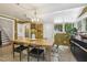 A dining room with a chandelier, a wooden table, and a plant in the corner at 613 S Fuquay Ave, Fuquay Varina, NC 27526