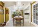 Dining room featuring unique wall color, chandelier, and view into kitchen at 613 S Fuquay Ave, Fuquay Varina, NC 27526