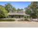 This home features charming curb appeal with a white picket fence, landscaped yard, and covered porch at 613 S Fuquay Ave, Fuquay Varina, NC 27526