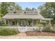 Charming home with a white picket fence and a cozy covered front porch with verdant plants at 613 S Fuquay Ave, Fuquay Varina, NC 27526