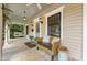 Relaxing front porch featuring a swing, seating, vintage lamps, and a painted ceiling at 613 S Fuquay Ave, Fuquay Varina, NC 27526