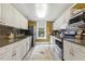 Kitchen boasts ample counter space, stainless appliances, and tiled backsplash at 613 S Fuquay Ave, Fuquay Varina, NC 27526
