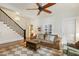 Spacious living room with coffered ceiling, neutral sofa, and staircase view at 613 S Fuquay Ave, Fuquay Varina, NC 27526