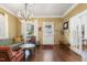 Relaxing living room with hardwood floors, large windows, and an elegant crystal chandelier at 613 S Fuquay Ave, Fuquay Varina, NC 27526