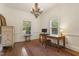 Bright office space features natural light, wood floors, desk, and elegant chandelier at 613 S Fuquay Ave, Fuquay Varina, NC 27526