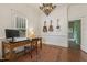 Office space showcases hardwood floors, chandelier, desk, and guitar wall decor at 613 S Fuquay Ave, Fuquay Varina, NC 27526