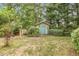Backyard storage shed nestled among trees at 613 S Fuquay Ave, Fuquay Varina, NC 27526