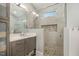 Modern bathroom features glass enclosed shower, neutral tile, vanity, and lots of storage at 705 Hinsdale St, Raleigh, NC 27605