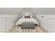 Cozy bedroom under the eaves with a decorative ottoman and neutral color palette at 705 Hinsdale St, Raleigh, NC 27605