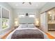 Comfortable bedroom with plenty of natural light, a barn door to the bathroom, and a ceiling fan at 705 Hinsdale St, Raleigh, NC 27605