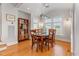 Bright dining room features hardwood floors, modern light fixture, and a table that seats six at 705 Hinsdale St, Raleigh, NC 27605