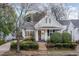 Charming home featuring a covered front porch, mature landscaping, and inviting curb appeal at 705 Hinsdale St, Raleigh, NC 27605