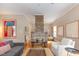 Open-concept living room featuring hardwood floors, natural light, and exposed brick fireplace at 705 Hinsdale St, Raleigh, NC 27605
