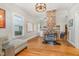 Bright living area with hardwood floors, exposed brick column and a vintage bar cart at 705 Hinsdale St, Raleigh, NC 27605