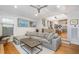 Open-concept living room featuring hardwood floors and natural light views into the kitchen at 705 Hinsdale St, Raleigh, NC 27605