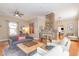 Spacious living room with a unique exposed brick fireplace and hardwood flooring at 705 Hinsdale St, Raleigh, NC 27605