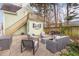 Inviting outdoor patio with comfortable seating, adjacent to an elevated deck and lush landscaping at 705 Hinsdale St, Raleigh, NC 27605