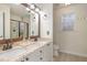 This bright bathroom features a double vanity with granite countertops and a window at 761 Raymond Dr, Clayton, NC 27527