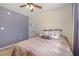 The bedroom features a ceiling fan, an accent wall, and comfortable neutral-colored carpet at 761 Raymond Dr, Clayton, NC 27527