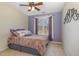The bedroom features a ceiling fan, a large window, and comfortable neutral-colored carpet at 761 Raymond Dr, Clayton, NC 27527