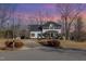 Lovely two-story home with a long driveway, manicured shrubs and mature trees at 761 Raymond Dr, Clayton, NC 27527
