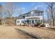 Charming two-story home featuring a covered porch, black shutters and mature landscaping at 761 Raymond Dr, Clayton, NC 27527