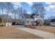 Inviting two-story home with a long driveway, a garage, and a well-maintained front yard at 761 Raymond Dr, Clayton, NC 27527