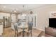 Bright eat-in kitchen with stainless steel appliances, white cabinets, tile floors, and access to the patio at 761 Raymond Dr, Clayton, NC 27527