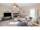 Comfortable living room featuring a fireplace, hardwood floors, ceiling fan, and lots of natural light at 761 Raymond Dr, Clayton, NC 27527