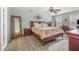 A lovely main bedroom features wood floors, a decorative mirror, and a ceiling fan at 761 Raymond Dr, Clayton, NC 27527