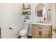 Stylish half bathroom with shiplap walls, modern vanity, round mirror, and decorative shelves at 761 Raymond Dr, Clayton, NC 27527