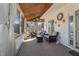 The screened porch features a wood ceiling, white columns, and comfortable seating at 761 Raymond Dr, Clayton, NC 27527